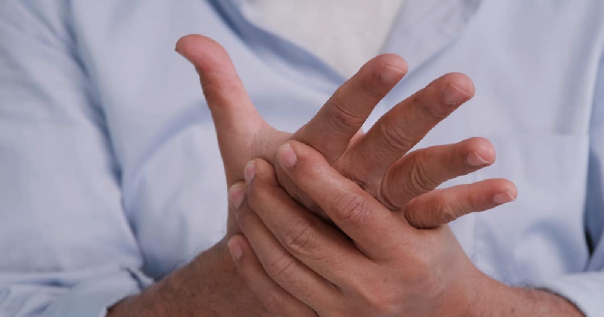 Person rubbing their hands in pain