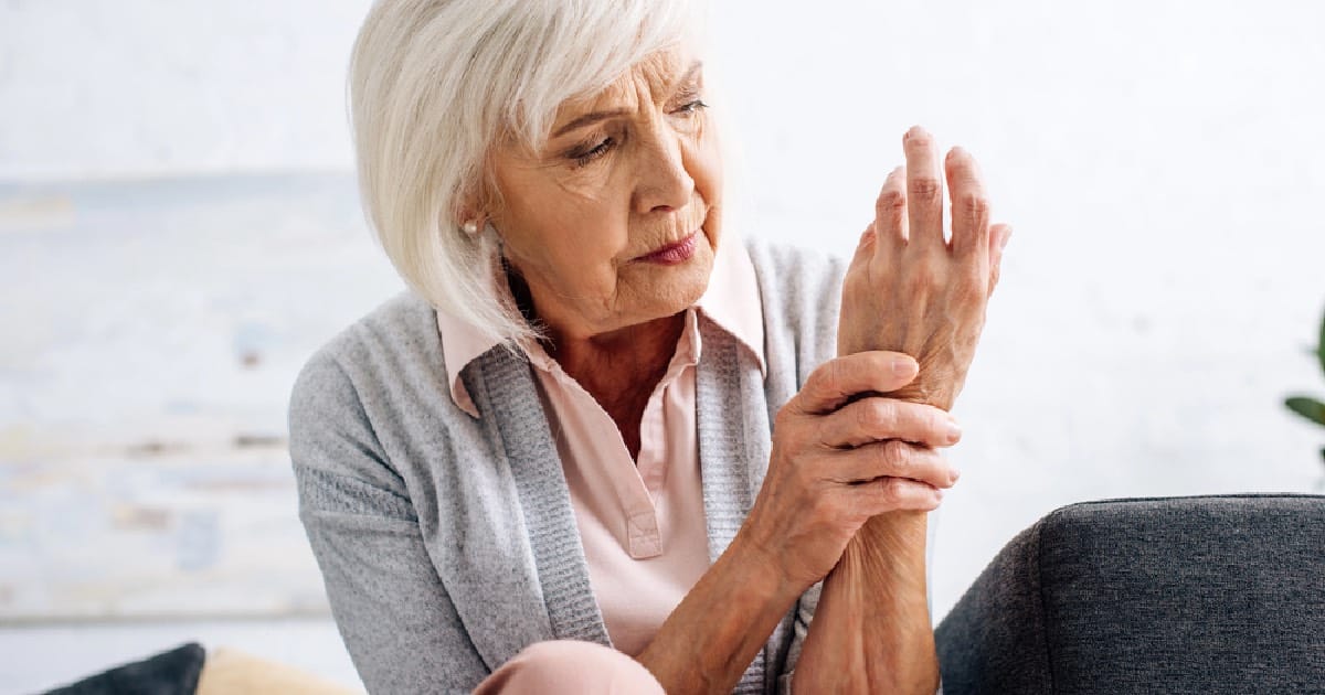 Senior woman holding hand from nerve pain