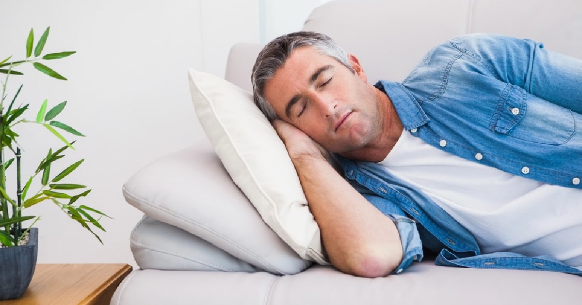 Man trying to find neuropathy relief by sleeping on couch