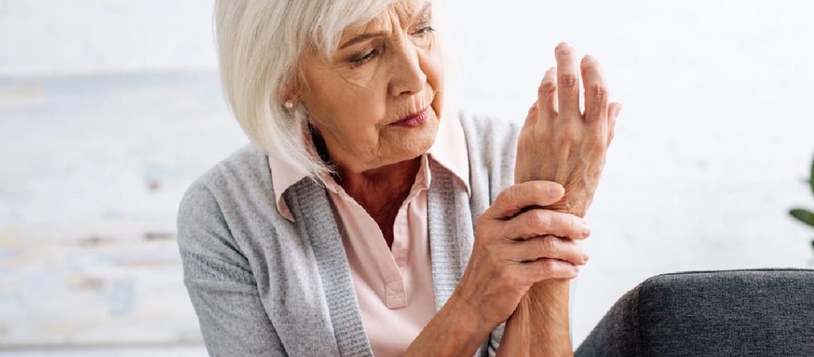 Senior woman holding hand from nerve pain